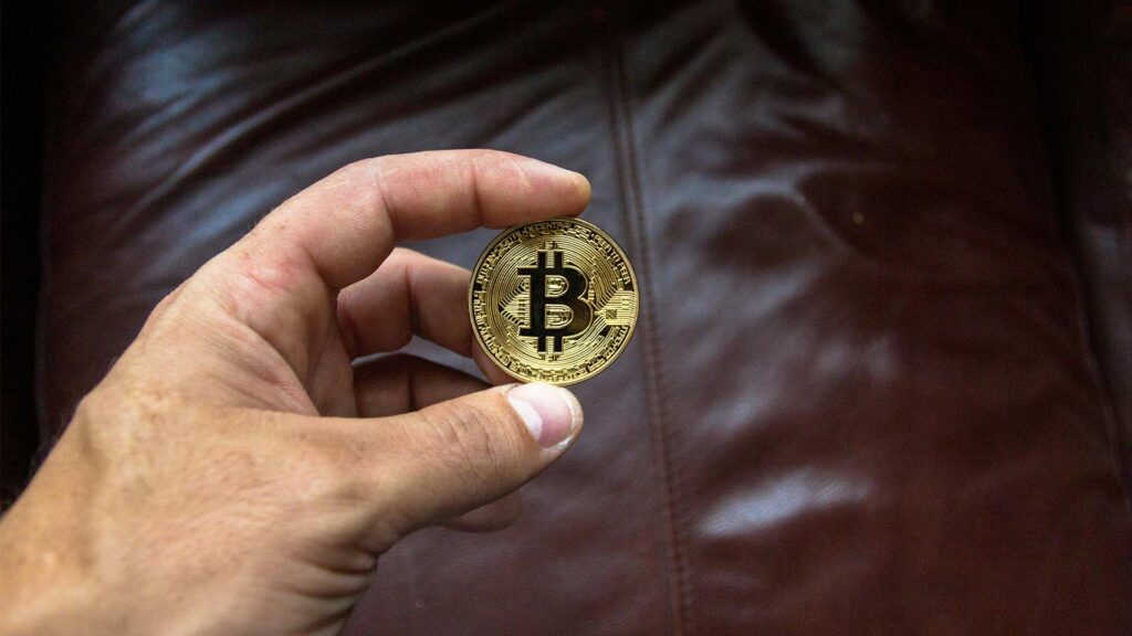 bitcoin cryptocurrency held by hand